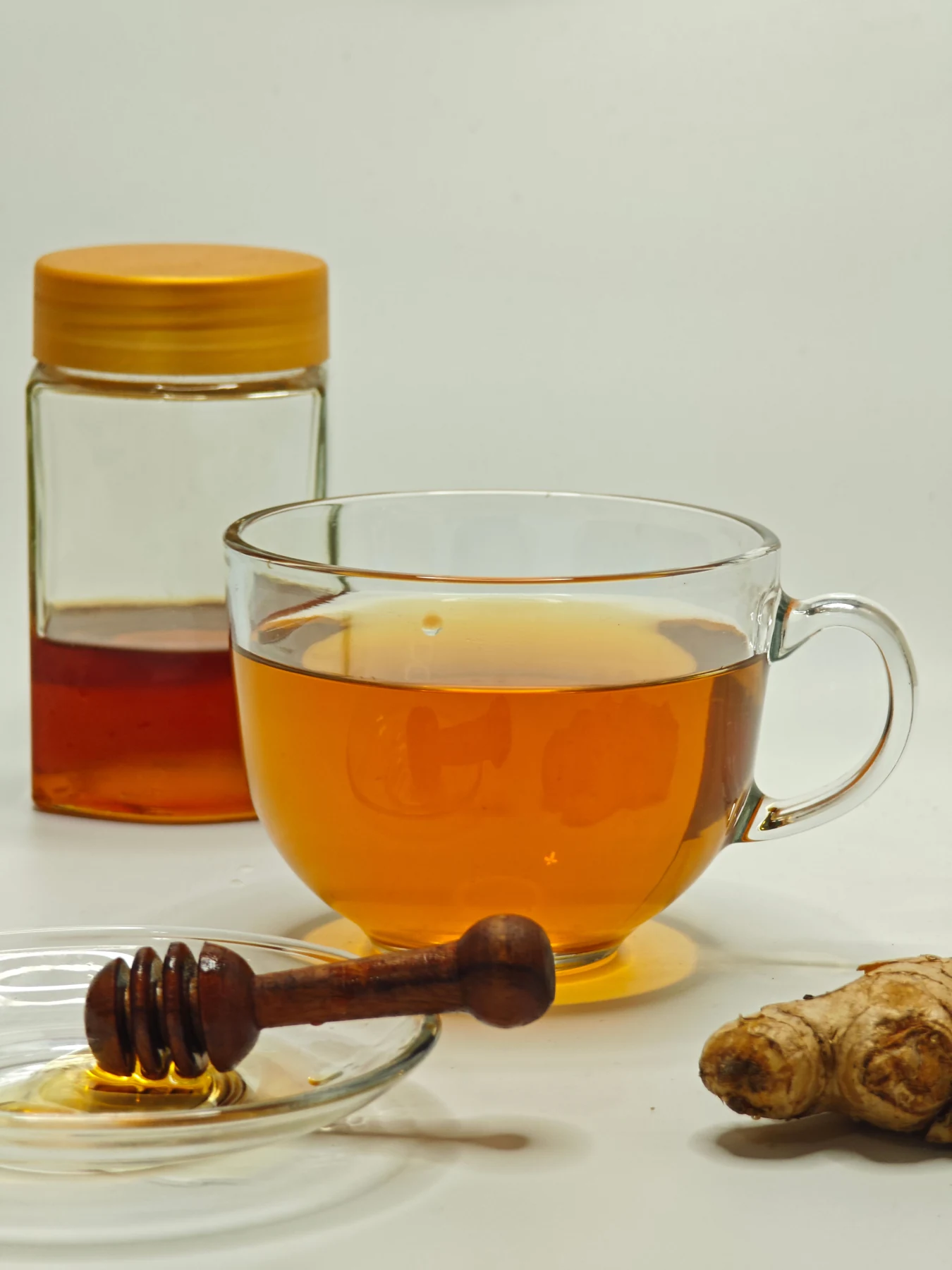 Tea beside fresh ginger and honey
